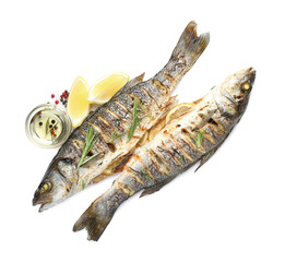 Tasty roasted seabass fish with spices isolated on white, top view. Homemade seafood dish