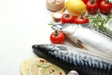 Seafood delicacies. Fresh raw mackerels and spices on white table, closeup. Space for text