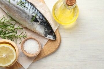 Seafood delicacies. Fresh raw mackerel and spices on light wooden table, flat lay. Space for text