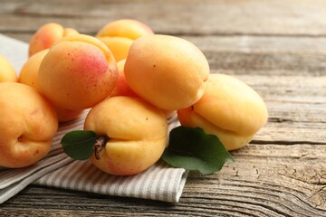 Fresh ripe apricots on wooden table, closeup