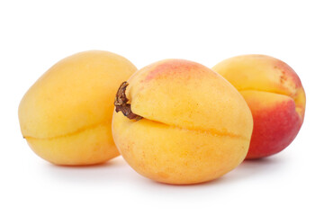 Three fresh ripe apricots isolated on white