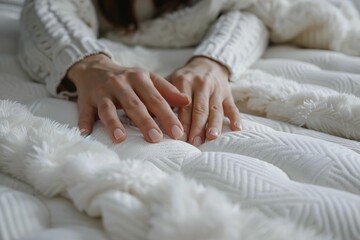 Woman enjoying softness of orthopedic mattress with memory foam topper, touching it with her hands