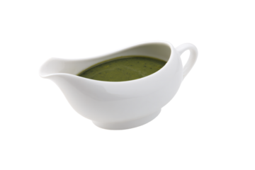 a gravy boat with a green sauce in it