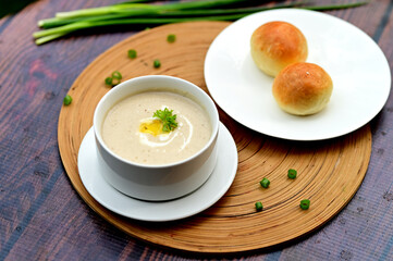 Homestyle Chicken Mushroom Soup with Warm Bread Roll on Side