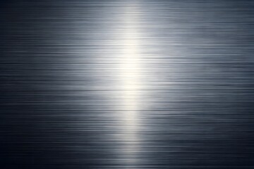 A dark brushed metal surface with a bright horizontal reflection of light