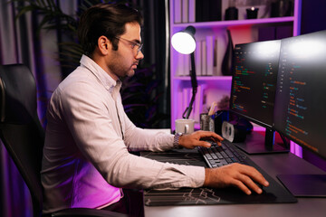 Working smart IT developer analyzing data software development on two pc screen, creating...