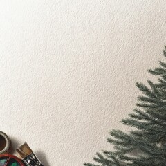 Christmas tree branch and art supplies on textured background  