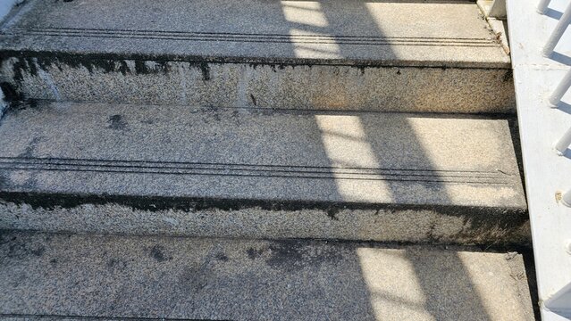 Worn Granite Outdoor Steps with Sunlight Shadows