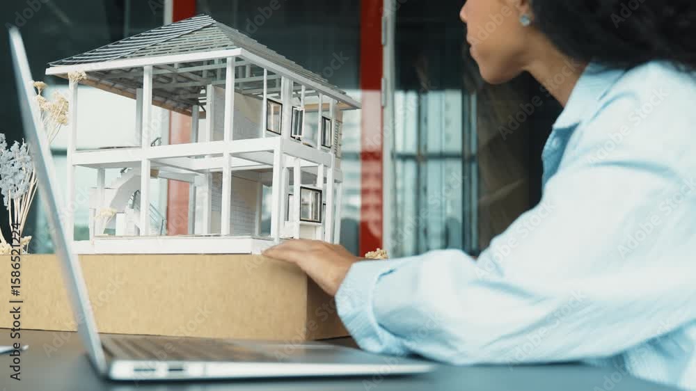 Poster closeup of hispanic architect hands engineer using laptop analysis house model structure. project ma