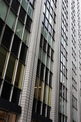The exterior wall of a retro-modern high-rise building is designed in a geometric pattern with large and small straight lines