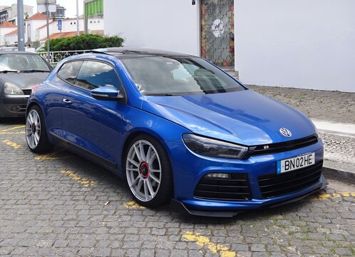 Tuned Volkswagen Scirocco parked on cobblestone street
