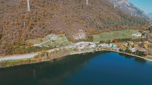 Aerial shot of the natural beauty of Lake Idro, with alpine scenery, calm waters, and quiet lakeside