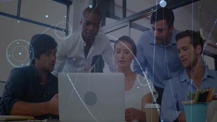 Team pointing at laptop starting data visualization overlays analyzing insights in tech office - Powered by Adobe