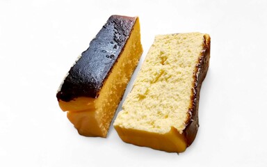 Two slices of Basque cheesecake are displayed on a white background, one with a darkly caramelized top and the other lighter.