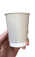 A hand holds a disposable paper cup with a beige sleeve. The cup has a white base, set against a clean white background.