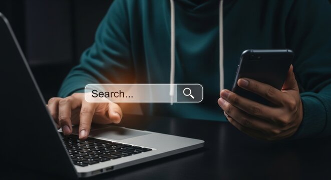 A person is searching online using a laptop and phone, navigating the digital world for information and connection