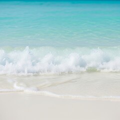 Turquoise waves gently wash over a pristine white sand beach.