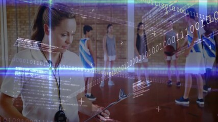 Coach scanning players and timing drill while binary data overlay animating on basketball court - Powered by Adobe