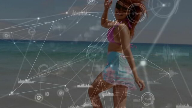 Woman bouncing right foot in surf initiating animated network graphics displaying data charts