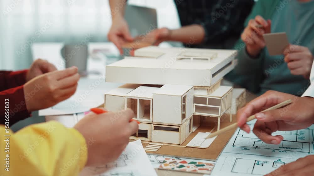 Poster a vibrant scene depicting hands engaged in a collaborative architecture design session, highlighting