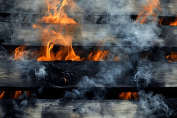 Close-up view of wooden pallets engulfed in flames, producing intense heat and thick smoke, creating a dramatic scene of fire