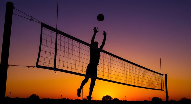 Silhouette of volleyball player spiking the ball over the net at sunset with a colorful sky view