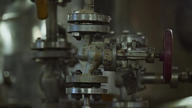 Close up of shiny clean pipe with elbow, branch and valve. Pipe flange joint
