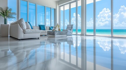 Bright sunlit living room with large windows overlooking the ocean and beach
