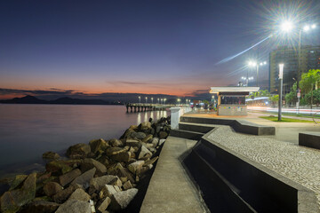 Santos city, Brazil. Ponta da Praia region. Sea observatory, snack bar, sidewalk and fisherman's deck during sunset. 