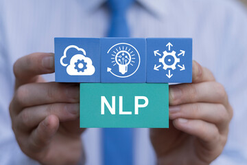 NLP Natural Language Processing AI Artificial intelligence or Neuro Linguistic Programming Concept. Business person holding blocks with icons sees acronym: NLP.