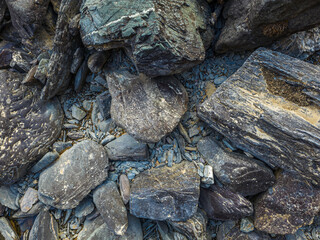 Various rocks on rugged ground in natural outdoor setting, high angle view