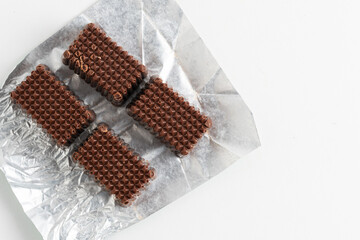 Chocolates in package on white background.