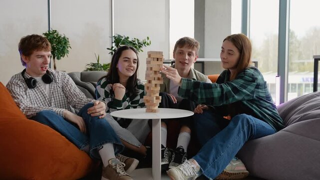 Students playing jenga board game and having fun
