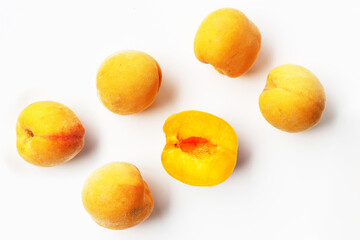 Fresh ripe apricots on a white background.