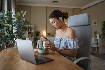 adult woman sit at table in the living room making healthy breakfast