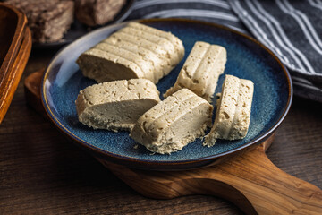 Halva. Sweet oriental dessert on plate on wooden table.