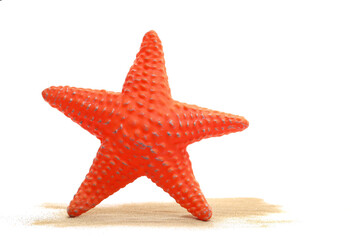 Plastic starfish in sand pile isolated on white, side view	