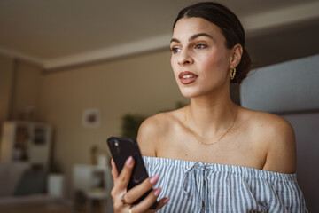 beautiful woman text messages or explore internet on mobile phone