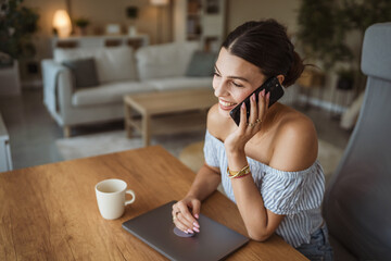 happy woman enjoy while drink coffee and talk on mobile phone at home