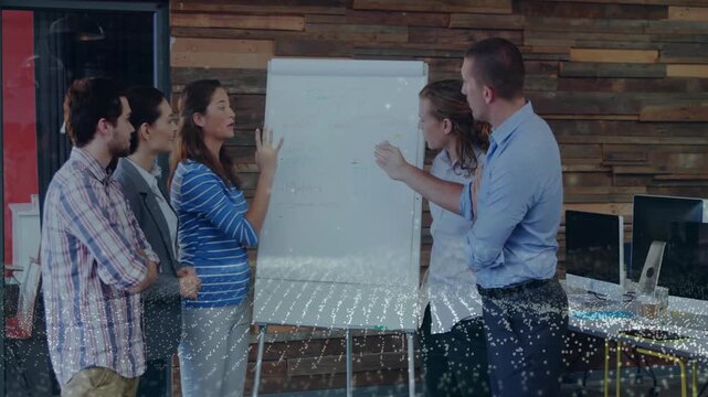 Pointing man initiating office meeting on chart while woman highlighting bullet points for teamwork