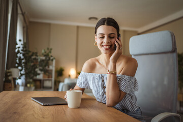 happy woman enjoy while drink coffee and talk on mobile phone at home