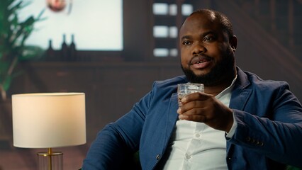 Classy gentleman getting a bit drunk with hiccups from strong blended whiskey glasses, having fun...