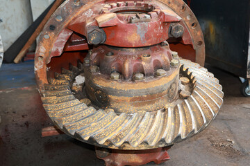 Dirty and broke Differential gear hub assembly need service on the floor.