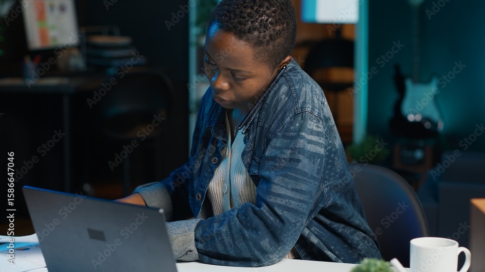 Poster african american teleworker receiving phone call from job colleague while working from home on lapto