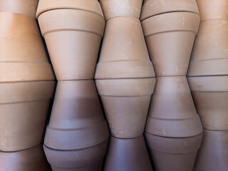 Clay pots stacked forming an abstract geometric background