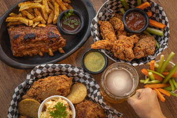 Fried Chicken, Chicken Wings and BBQ Ribs Plate with Beer 