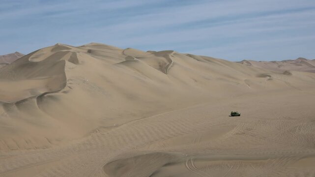 Sand dunes of Huacachina desert. Golden ripples, arid landscape, Peru, natural patterns, dry terrain, travel destination, South America, scenic view, wind-shaped dunes. Huacachina oasis in Peru