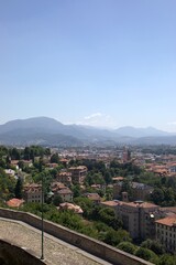Naklejka premium Panoramic cityscape of The Venetian Walls, Bergamo with greenery and distant Alps, Italy