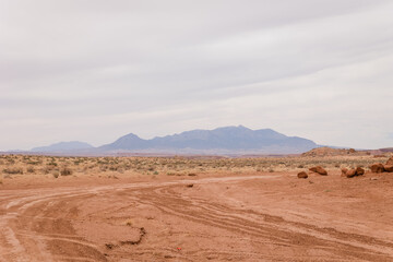 Striking red rock formations rise from the arid desert floor, creating a bold and rugged landscape shaped by time and erosion.