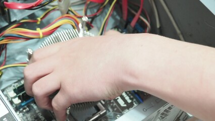 technician hold the screwdriver for repairing the laptop. computer hardware, repairing, upgrade and...